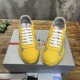 Top front view of Prada yellow low-top trainers with white laces in yellow and grey