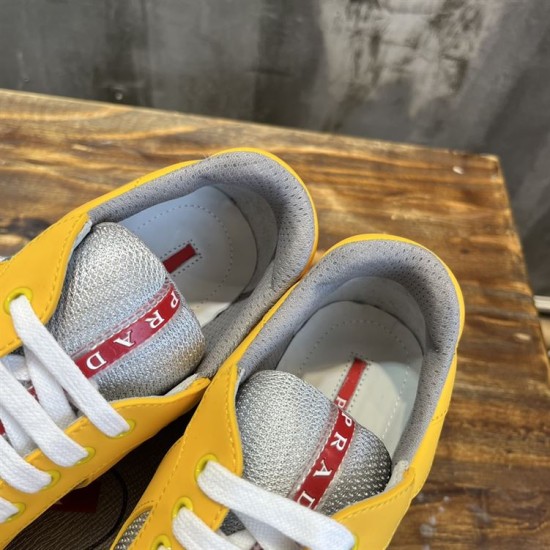 Padded interior collar and tongue logo detail of Prada yellow trainers in yellow and grey