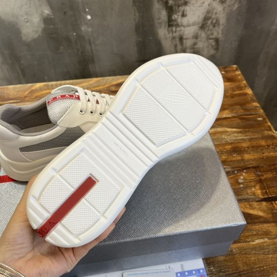 Underside tread pattern of white rubber sole with red logo accent in white and grey