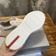 Underside tread pattern of white rubber sole with red logo accent in white and grey