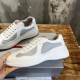 Side view detail of Prada America's Cup trainer held by hand in white and grey