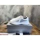 Pair of white Prada America's Cup trainers resting on a shoebox in white and grey