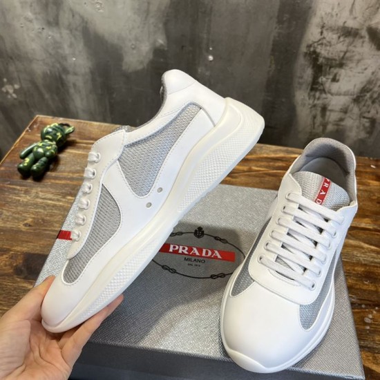 Angled top view showing mesh and rubber upper of Prada America's Cup trainer in white and grey