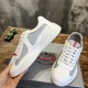 Angled top view showing mesh and rubber upper of Prada America's Cup trainer in white and grey