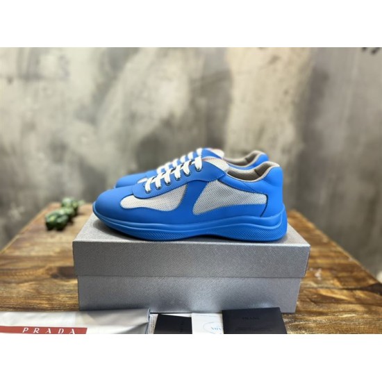 Prada America's Cup Blue Trainers Pair on Box in blue and grey Pair of Prada America's Cup blue trainers resting on a silver shoe box in blue and grey