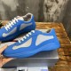 Prada America's Cup Blue Trainer Lateral Profile in blue and grey Hand holding a Prada blue rubber and grey mesh trainer showing lateral side details