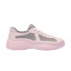 Studio lateral profile of pink and grey rubber trainer on white backdrop
