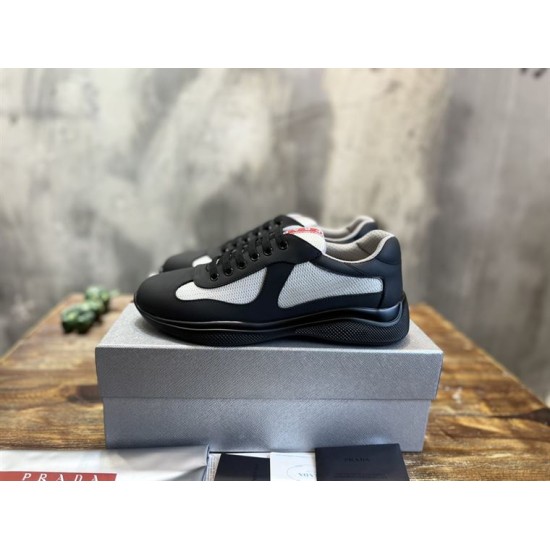 Boxed Side View Prada Trainers in black and grey Side perspective of Prada black and grey trainers resting on shoe box