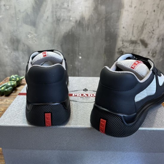 Heel View Prada Trainers in black and grey Rear heel view showing black rubber heel counters and red logo tabs in black and grey