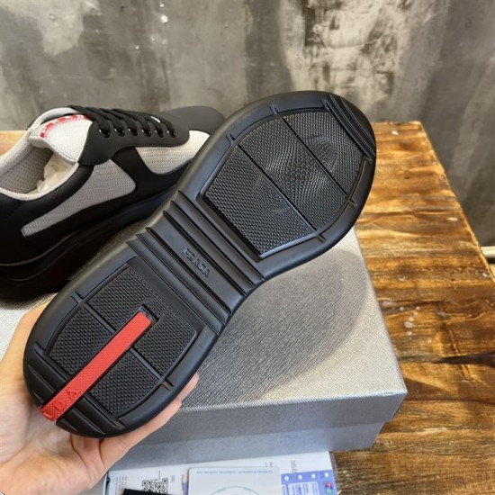 Outsole Tread Prada Trainer in black and grey Underside view of black rubber sole featuring red logo inlay in black and grey
