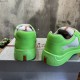 Rear view showing bright green heels with red logo inserts in green and grey