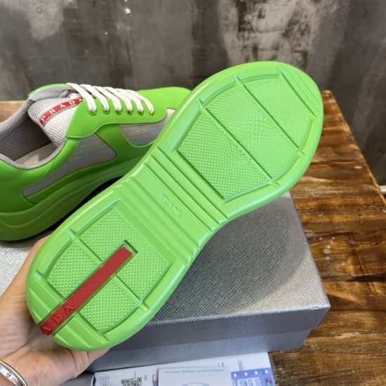 Underside view of green treaded rubber sole with red logo accent in green and grey