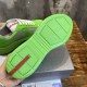 Underside view of green treaded rubber sole with red logo accent in green and grey