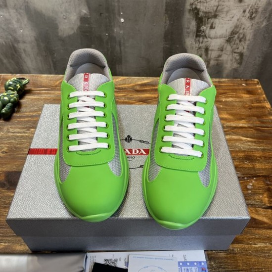 Top-down front angle of green rubber trainers with white laces and grey mesh