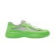 Side profile view of green and grey soft rubber trainers on a white background
