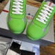 Close-up front view of bright green rubber toe caps and grey mesh upper details
