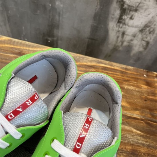 Close-up view of padded collar, grey lining, and red logo tab on tongue in green and grey