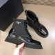 Prada Black Boot Outer Profile Detail in black and white Hand holding a Prada brushed leather and nylon boot in black showing outer side detail in black and white