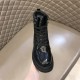 Prada Brushed Leather Boot Front Angle in black and white Front perspective of a black Prada boot displaying polished toe cap and lacing in black and white