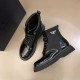 Prada Black Brushed Leather And Nylon Boots Pair in black and white Pair of black Prada brushed leather and nylon boots displayed on a neutral surface in black and white