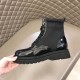 Prada Black Boot Medial Side in black and white Medial side view of black Prada brushed leather and nylon boot showcasing lugged rubber sole in black and white