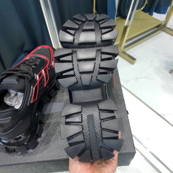Prada Cloudbust Thunder Sole Tread View in black and red Underside of black Prada trainer showing heavy lugged tread pattern and logo in black and red