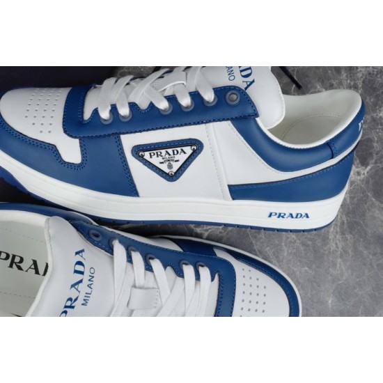 Prada Downtown Trainer Triangle Logo Plaque Detail in blue and white Close-up detail of Prada Downtown trainer enamel triangle logo plaque in blue and white