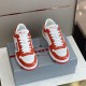 Front View of Prada Downtown Leather Trainers in orange and white Front facing view of orange and white Prada Downtown leather trainers showing toe box and laces