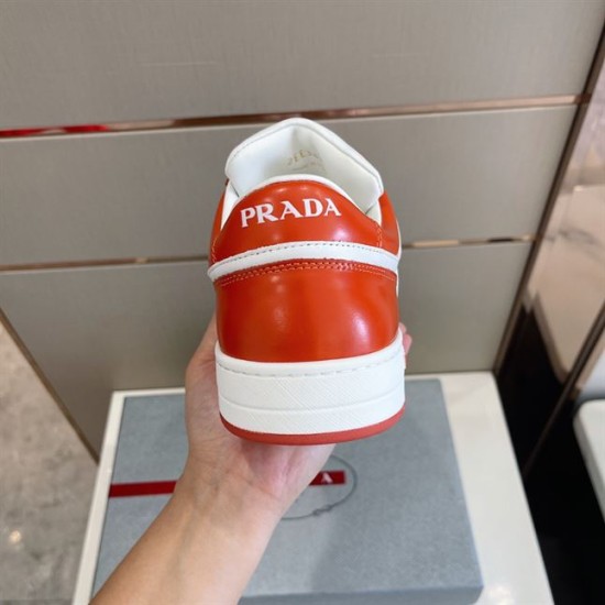 Heel View of Prada Downtown Leather Trainer in orange and white Rear view of Prada Downtown trainer showing orange leather heel counter and white branding