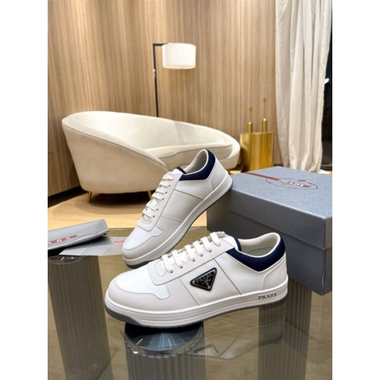 Prada White And Navy Trainers Angled Profile Angled side view of white and navy Prada trainers on display