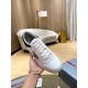 Prada White And Navy Trainer Front Perspective Hand holding a single Prada white and navy trainer showing the toe box and lacing detail