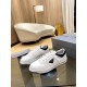 Prada White And Navy Low-Top Trainers Pair View Pair of Prada white and navy low-top trainers displayed on a glass table next to a shoebox