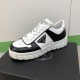 Prada Leather Low Top Trainers In Black And White - Lateral View Angled view showing lateral triangle logo on Prada black and white leather trainer