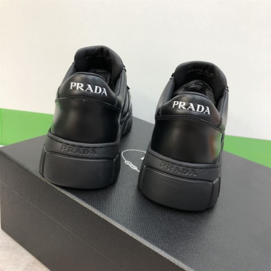 Prada Black Leather Trainer Heel Branding Detail Rear view of both Prada black leather trainers displaying printed and embossed heel branding
