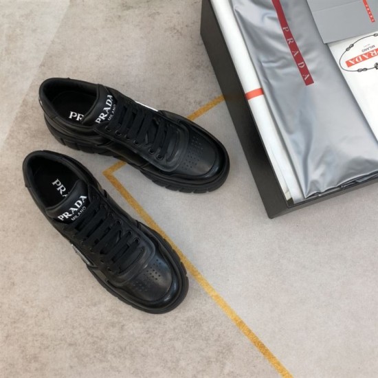 Prada Black Leather Chunky Trainers Top View Top-down view of Prada black leather chunky trainers positioned next to product packaging
