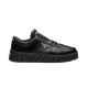 Prada Black Leather Trainer Lateral Profile Lateral side view of single Prada black leather trainer on plain white background