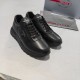 Pair of Prada Black Leather Low Top Trainers Angled View Pair of Prada Black Leather Low Top Triangle Logo Trainers angled view with packaging
