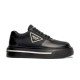Studio Side Profile of Black Prada Platform Trainer in black and white Studio profile shot of a single black Prada Macro Re-Nylon and brushed leather trainer on a plain white background.