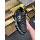 Handheld Profile of Prada Black Trainer in black and white Handheld angle of a black Prada Re-Nylon trainer displaying the platform sole with white stripe accent.