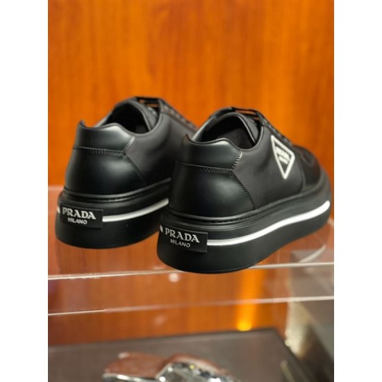 Rear Heel Detail of Black Prada Trainers in black and white Rear view of black Prada platform trainers showing the heel counters with rubber Prada Milano badges in black and white