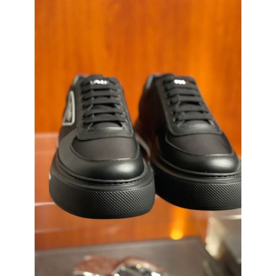 Front View of Prada Black Platform Trainers in black and white Front view of black Prada platform trainers detailing the textured rubber toe cap and flat lace arrangement in black and white