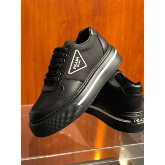 Angled View of Prada Black Macro Trainers in black and white Angled front and side view of black Prada platform trainers highlighting the thick rubber sole and lace-up design in black and white