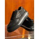 Angled View of Prada Black Macro Trainers in black and white Angled front and side view of black Prada platform trainers highlighting the thick rubber sole and lace-up design in black and white
