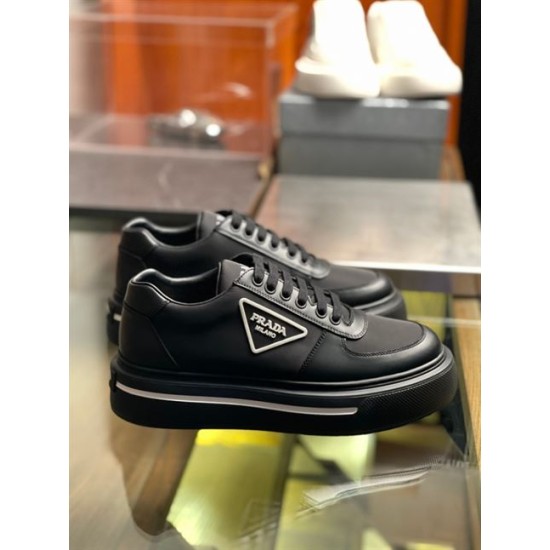 Prada Black Leather and Re-Nylon Trainers Pair in black and white Pair of black Prada platform trainers positioned on a display shelf showing side profile and triangle logo in black and white