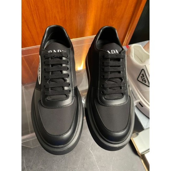 Top-Down View of Black Prada Trainers in black and white Top-down view of black Prada Macro Re-Nylon trainers showing toe caps, laces, and branded tongues in black and white