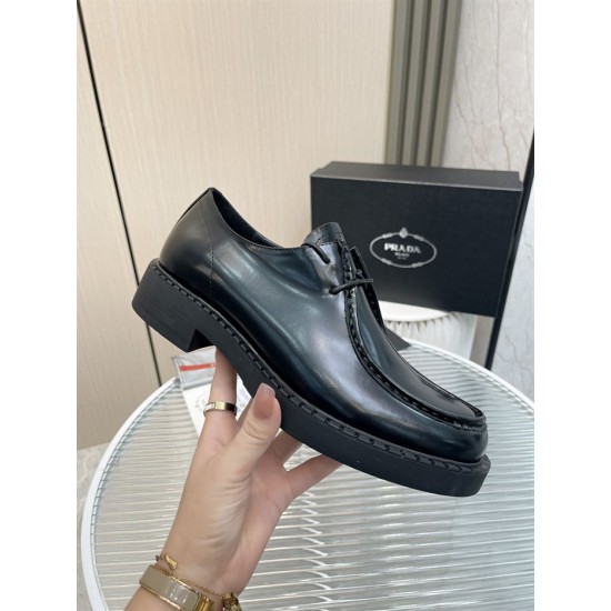 Prada Brushed Leather Monolith Handheld View in black Hand holding a black Prada brushed leather lace-up shoe showing profile and chunky sole