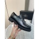 Prada Brushed Leather Monolith Handheld View in black Hand holding a black Prada brushed leather lace-up shoe showing profile and chunky sole