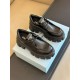 Pair of black Prada Monolith lace-up shoes displayed on a shoebox