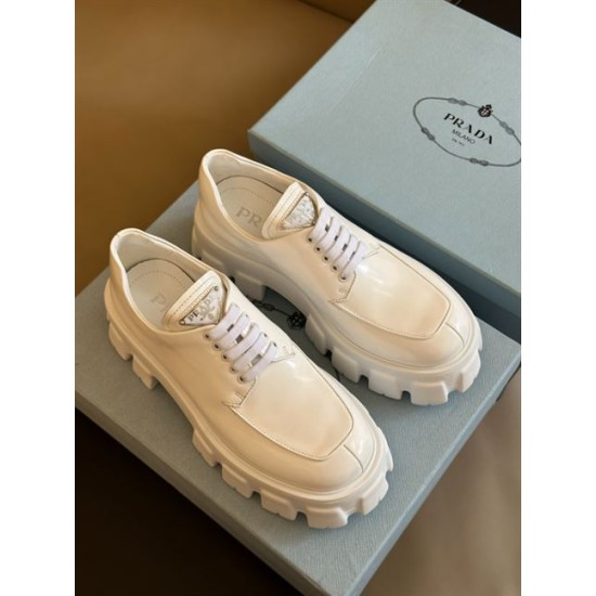 Prada Monolith White Lace-Up Shoes Top Angle Top angled view of white Prada Monolith lace-up shoes resting on shoe box