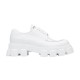 Prada Monolith White Shoe Lateral Profile Lateral view of Prada Monolith white leather lace-up shoe against plain backdrop
